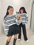 Knitted sweater with striped pattern in white and black