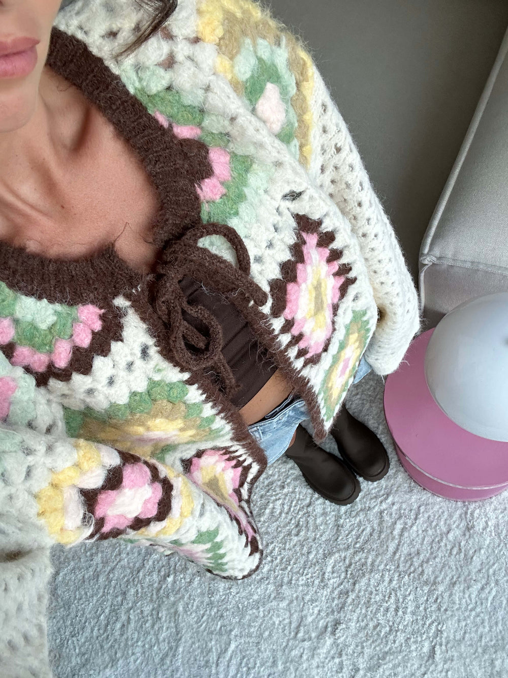 Detailansicht der gehäkelten Strickjacke in Creme mit bunten quadratischen Mustern in Rosa, Gelb, Grün und Schwarz, präsentiert von Lisa für lisas-boutique.de