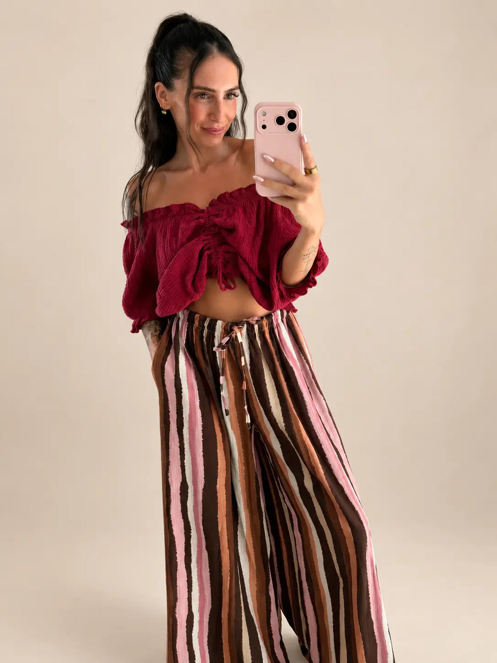 Women’s ruched muslin blouse in Bordeaux with striped trousers, styled in an outfit | Lisa’s Boutique