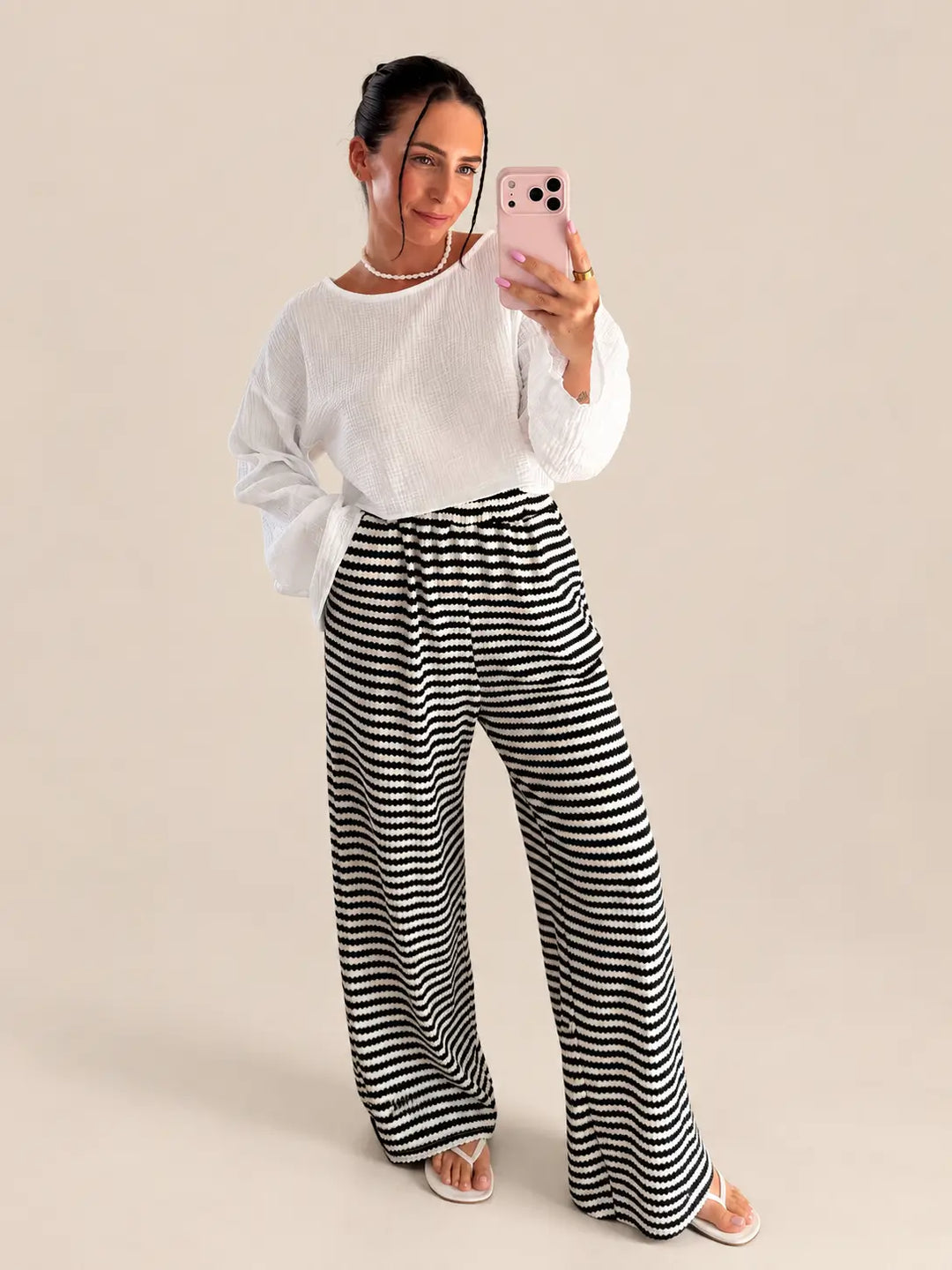 Gestreepte gebreide broek dames in Zwart met mousseline longsleeve in Wit, volledig aanzicht aan het model | Lisa’s Boutique