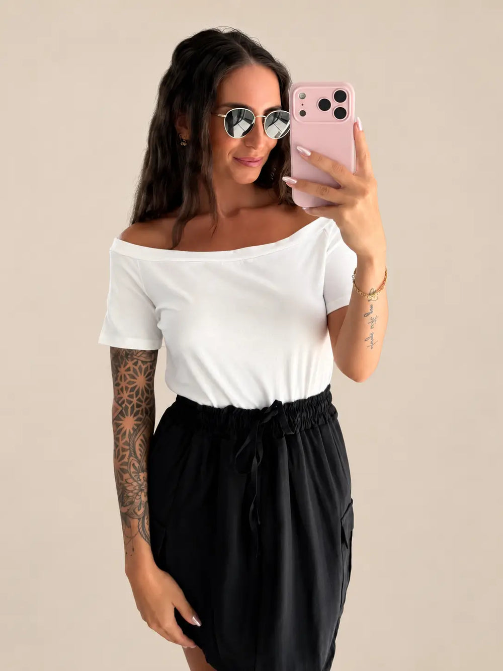 Women’s off shoulder top in White with a skirt, styled in an outfit | Lisa’s Boutique