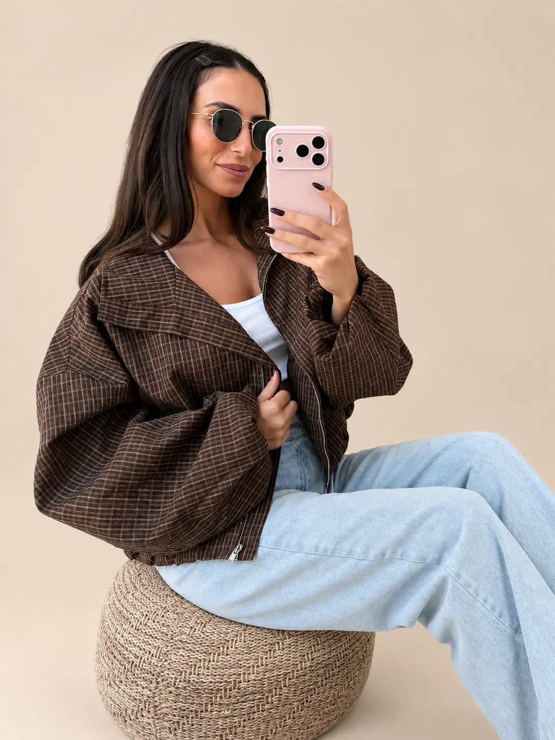Women’s brown oversized check jacket with a large collar, seated with light jeans | Lisa’s Boutique