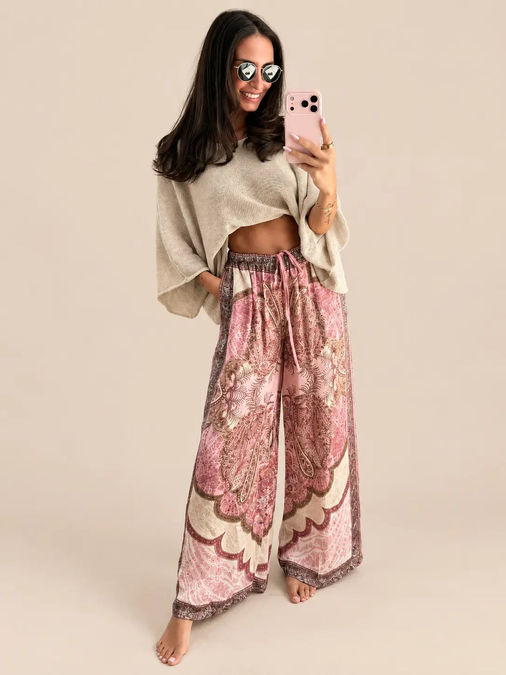 Women’s satin trousers in Rose with a paisley print and a beige lightweight sweater | Lisa’s Boutique