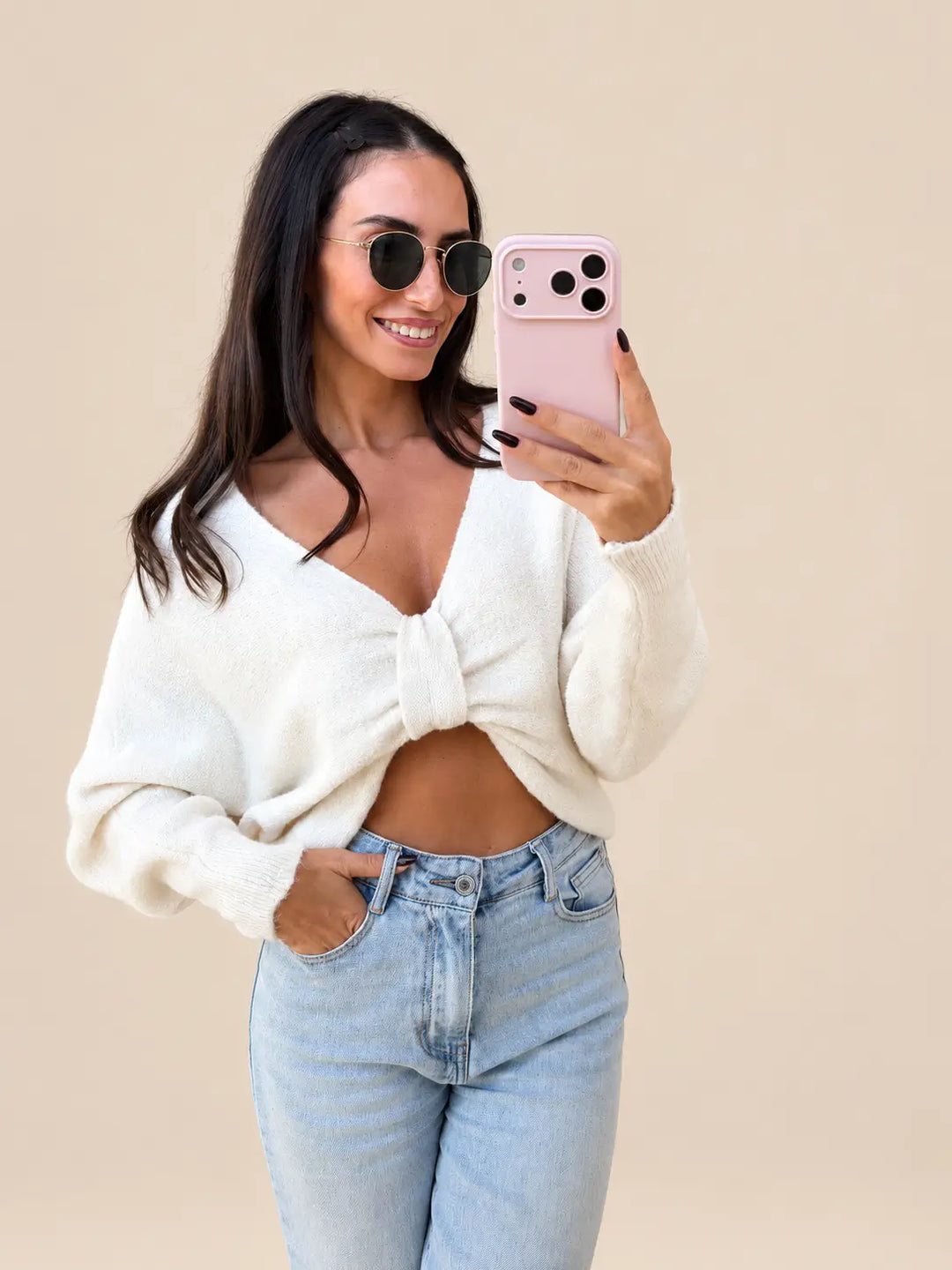 Women’s beige fine knit bow jumper with a front knot detail, with light jeans | Lisa’s Boutique
