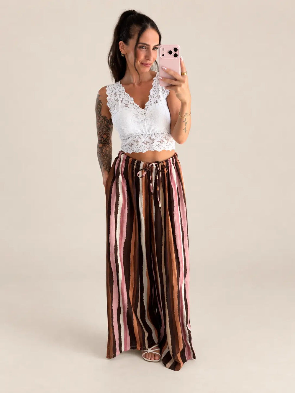 Women’s lace bustier in White with brown striped trousers, styled in an outfit | Lisa’s Boutique
